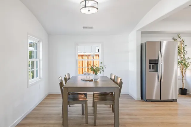 a view of a dining room with furniture and window