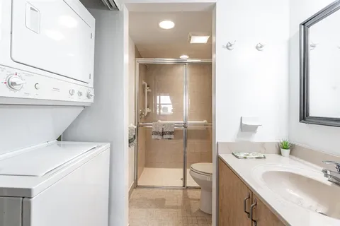 a bathroom with a sink toilet and shower