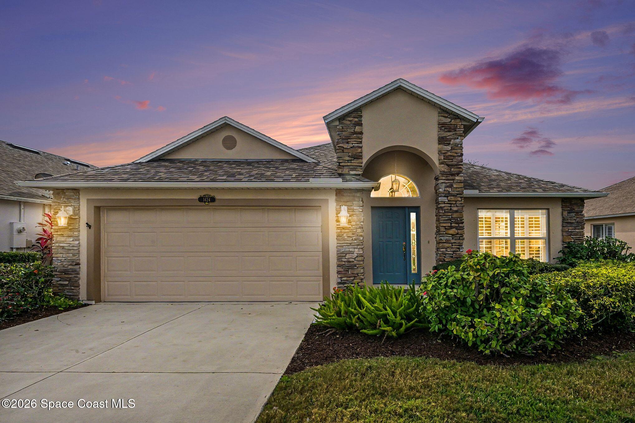 1424 Boca Rio Drive Melbourne, FL 32940 - Photo 1 of 50 a front view of a house with a garden