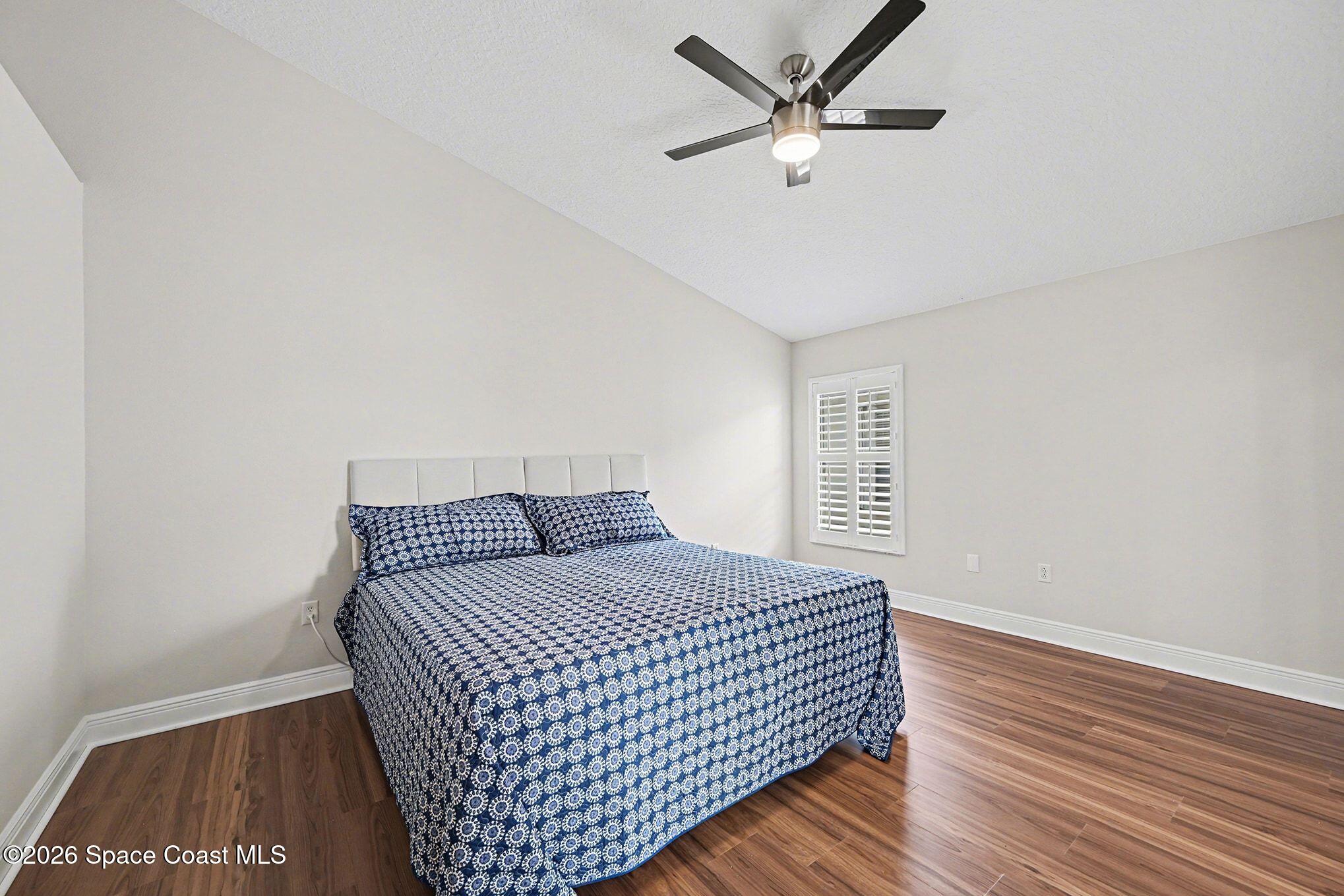1424 Boca Rio Drive Melbourne, FL 32940 - Photo 25 of 50 a bedroom with a bed and a ceiling fan