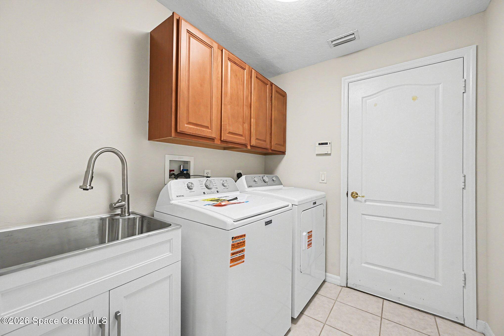 1424 Boca Rio Drive Melbourne, FL 32940 - Photo 37 of 50 a utility room with dryer and washer