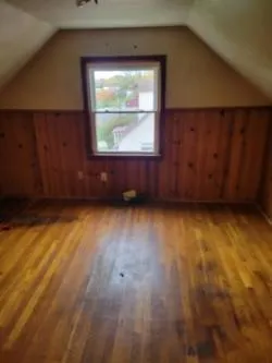 a kitchen with a refrigerator and wooden floor