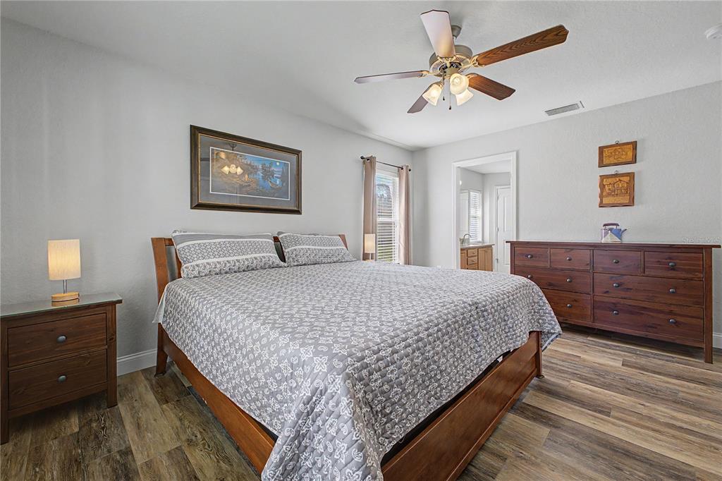 11213 Flock Avenue Weeki Wachee, FL 34613 - Photo 21 of 46 a bedroom with a bed and a dresser