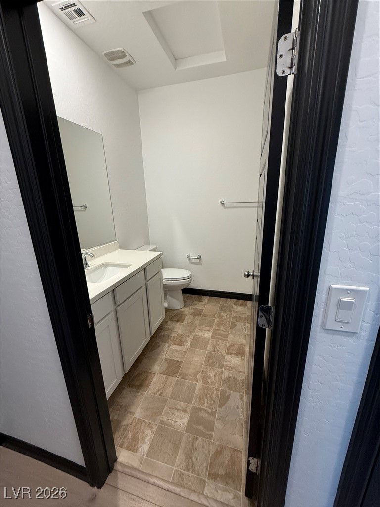 7368 North Decatur Boulevard, Unit 1 North Las Vegas, NV 89084 - Photo 8 of 17 Half bath with vanity and stone finish floors