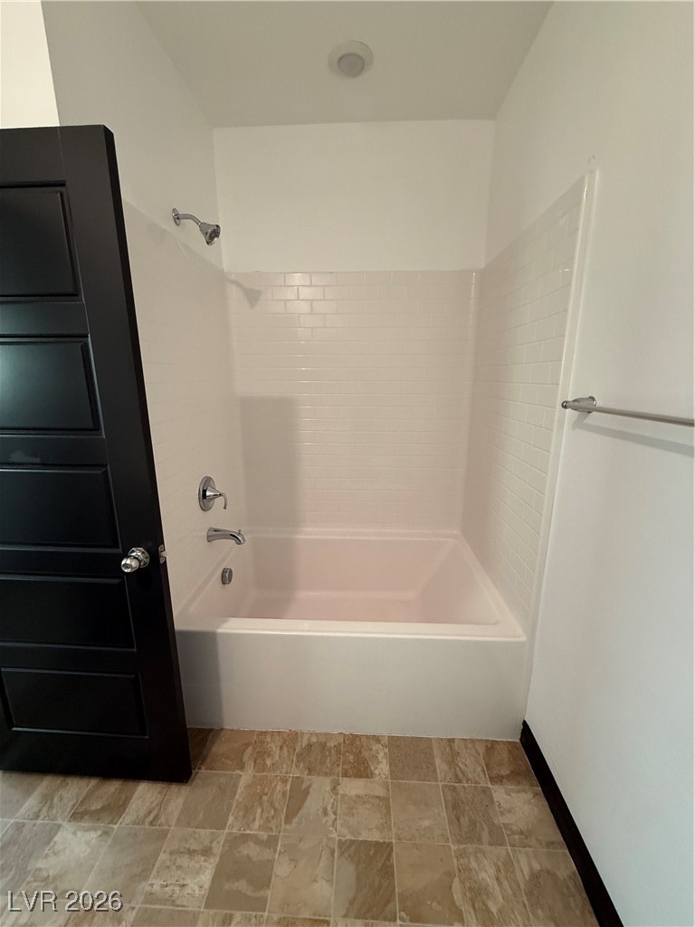 7368 North Decatur Boulevard, Unit 1 North Las Vegas, NV 89084 - Photo 10 of 17 Full bathroom featuring tub / shower combination and stone finish flooring