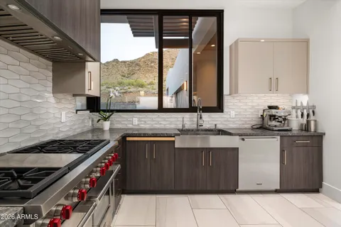 a living room with furniture and floor to ceiling windows