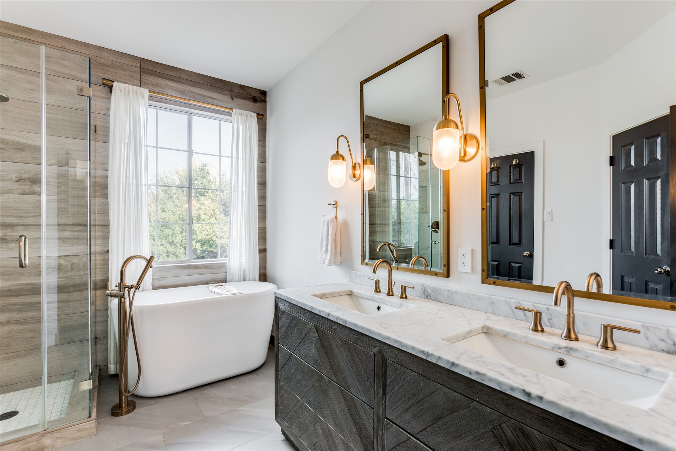 411 West St Elmo Road, Unit 35 Austin, TX 78745 - Photo 18 of 21 Bathroom featuring double vanity, a stall shower, and a freestanding tub