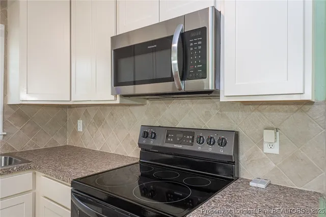 a kitchen with a stove and a microwave