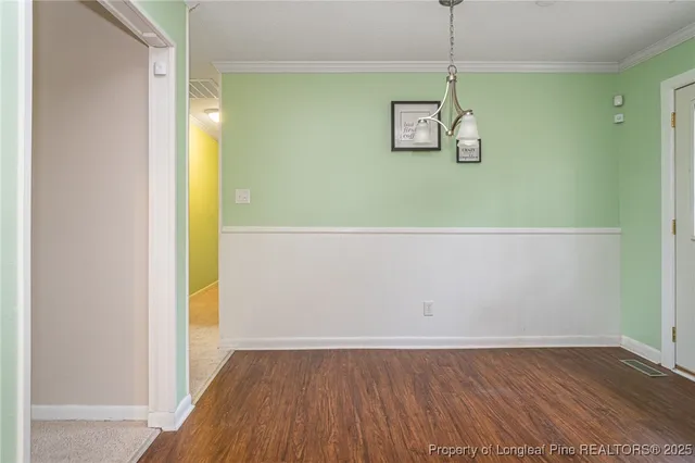 a view of room with wooden floor