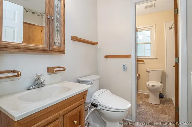 a white toilet sitting next to a bathroom sink