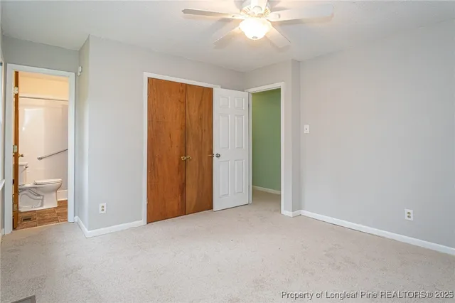 an empty room with fan and entrance