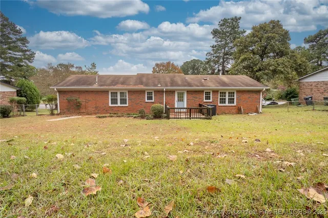 a front view of a house with a yard table and chairs