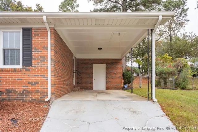 a front view of a house with a yard and potted plants