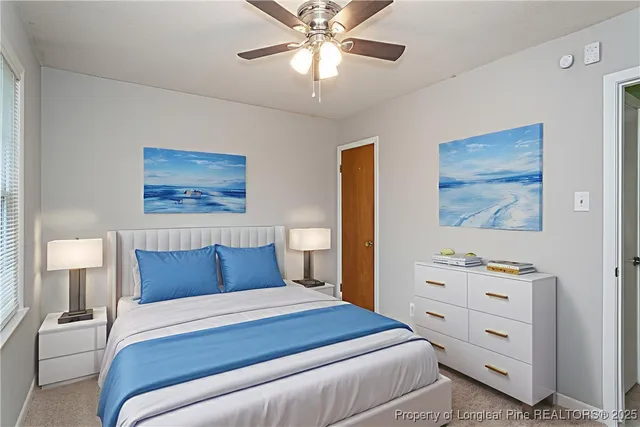 a bedroom with a bed and a lamp on the dresser