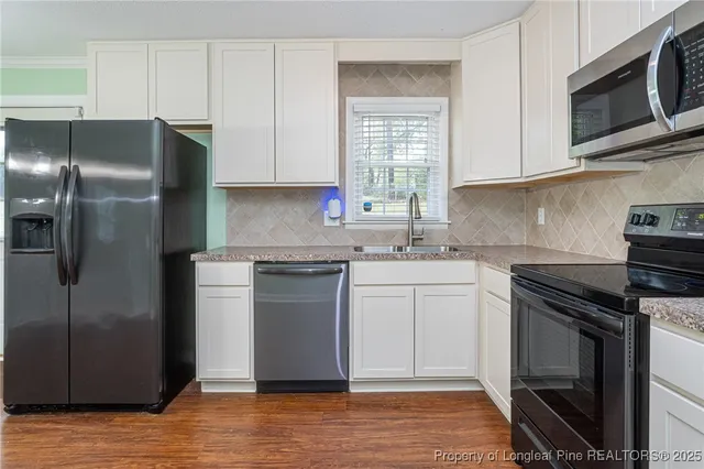a kitchen with a refrigerator stove and microwave