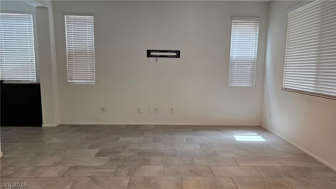 891 Earth Luster Road Las Vegas, NV 89178 - Photo 2 of 20 Large tile flooring and abundant natural light define this versatile living space.
