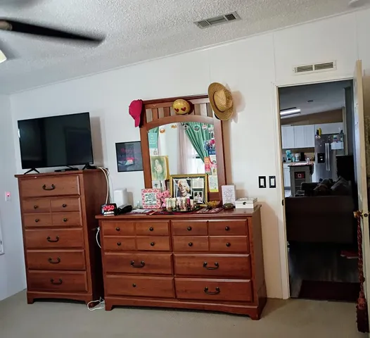 a room with a dresser and a flat screen television