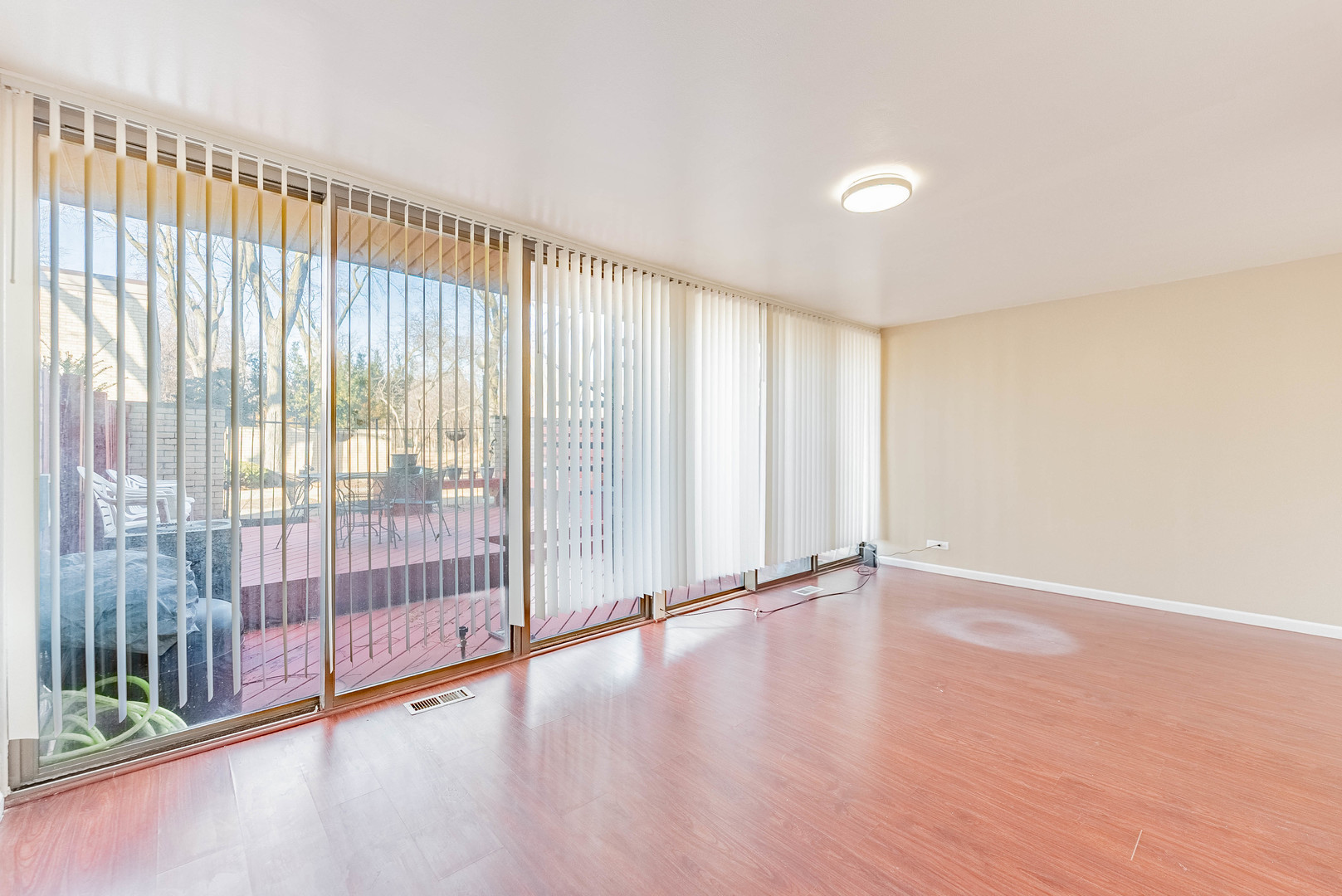 1320 West Arthington Street, Unit 1 Chicago, IL 60607 - Photo 3 of 19 a view of an empty room with wooden floor and a window