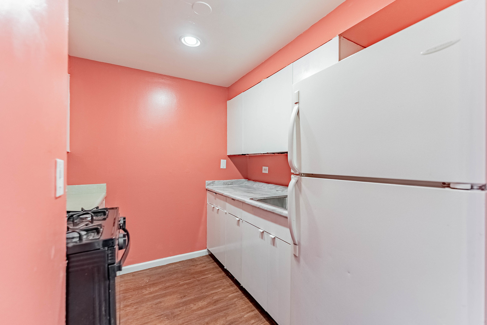 1320 West Arthington Street, Unit 1 Chicago, IL 60607 - Photo 6 of 19 a kitchen with a refrigerator and cabinets