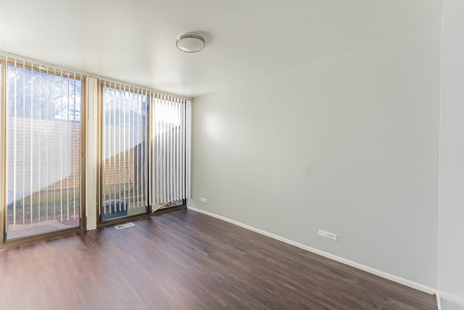 1320 West Arthington Street, Unit 1 Chicago, IL 60607 - Photo 9 of 19 an empty room with wooden floor and windows