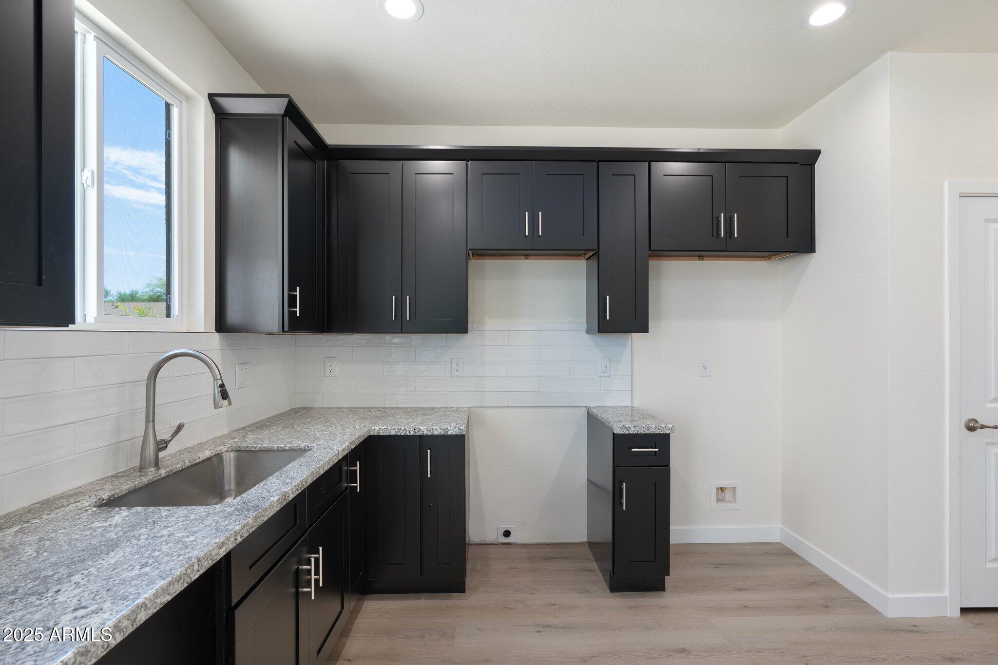 141 West Latona Road Phoenix, AZ 85041 - Photo 6 of 13 a kitchen with a sink and a refrigerator