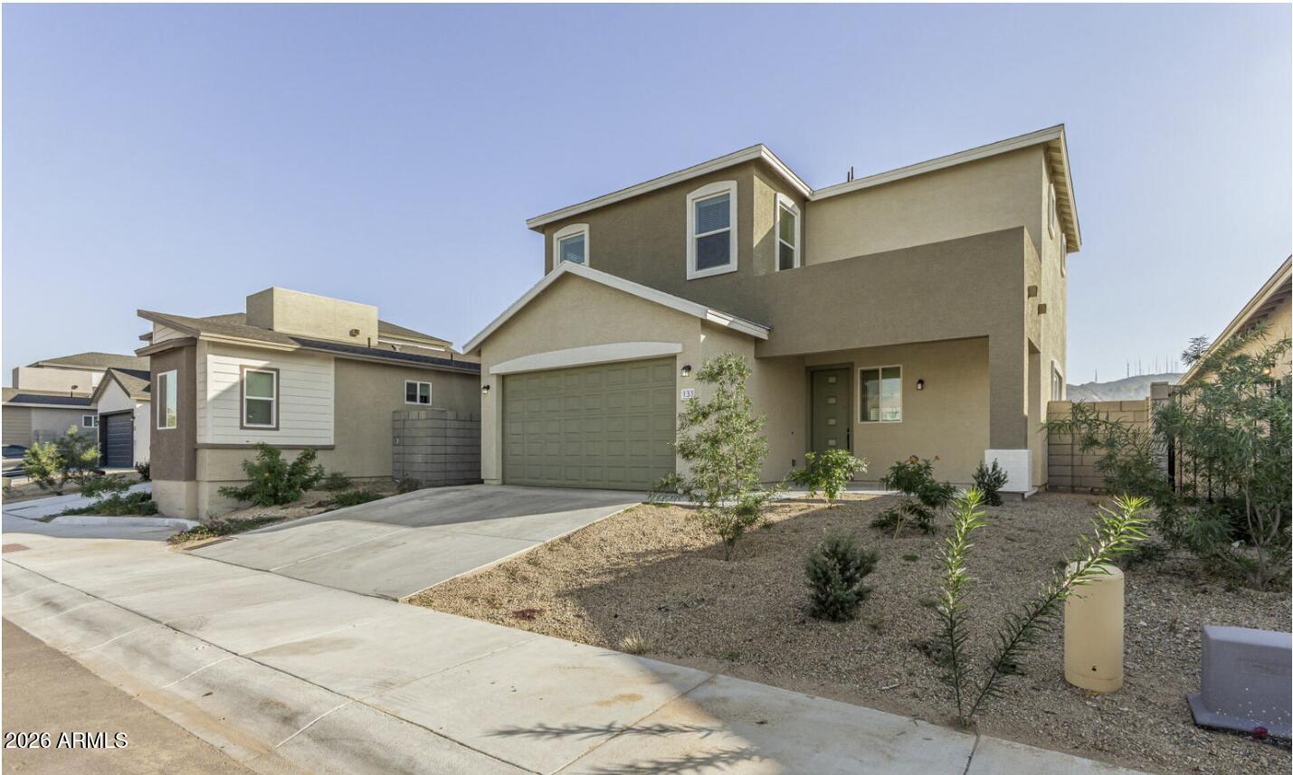 141 West Latona Road Phoenix, AZ 85041 - Photo 8 of 13 a front view of a house with a yard and garage