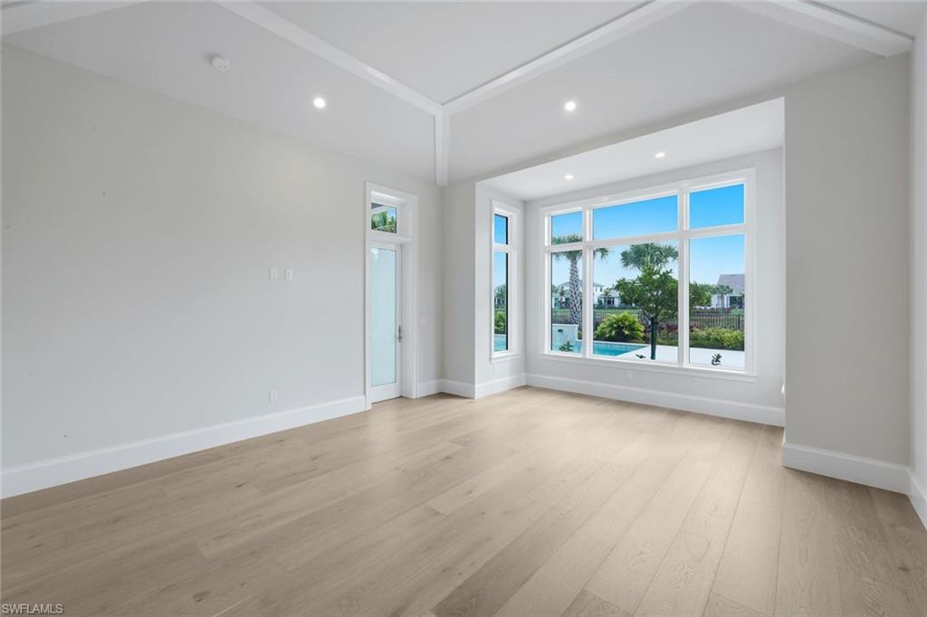 16728 Enclave Circle Naples, FL 34110 - Photo 17 of 49 Unfurnished room featuring light wood finished floors and recessed lighting