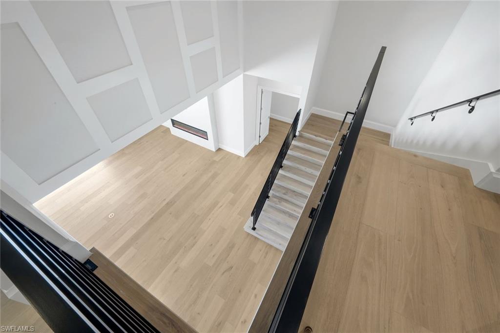 16728 Enclave Circle Naples, FL 34110 - Photo 27 of 49 Stairway featuring wood finished floors