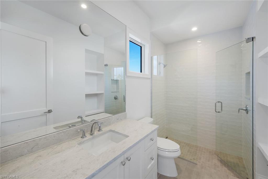 16728 Enclave Circle Naples, FL 34110 - Photo 31 of 49 Bathroom with a shower stall, vanity, and recessed lighting