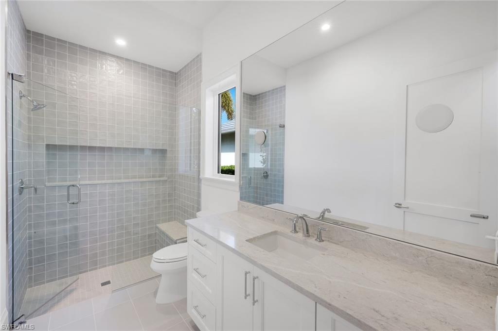 16728 Enclave Circle Naples, FL 34110 - Photo 35 of 49 Full bath featuring vanity, light tile patterned floors, a shower stall, and recessed lighting