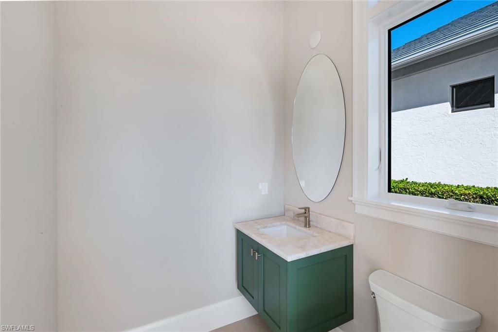 16728 Enclave Circle Naples, FL 34110 - Photo 37 of 49 Bathroom featuring vanity and toilet
