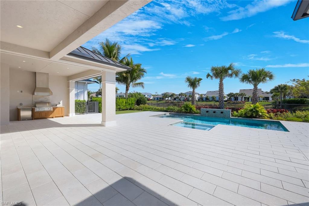 16728 Enclave Circle Naples, FL 34110 - Photo 43 of 49 Integrated pool / spa featuring a patio, a residential view, area for grilling, and a fenced backyard