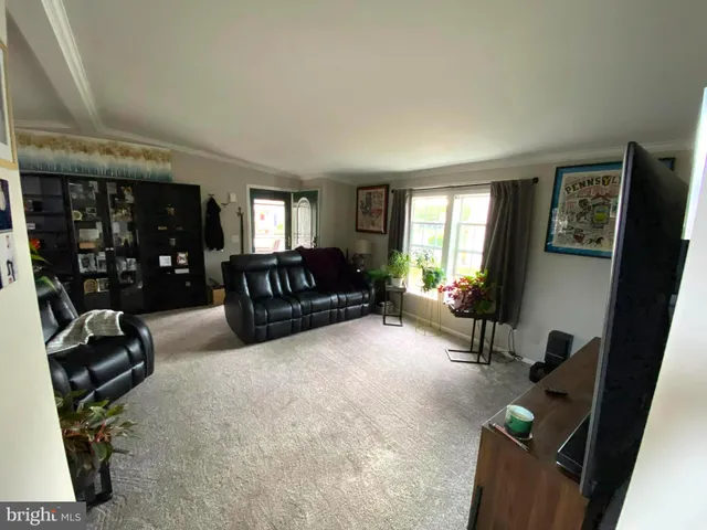 a living room with furniture a window and gym equipment