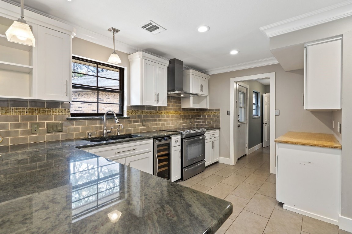 a kitchen with stainless steel appliances granite countertop a stove sink and refrigerator