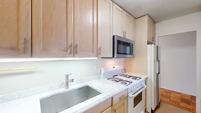 a kitchen with a sink stove and microwave