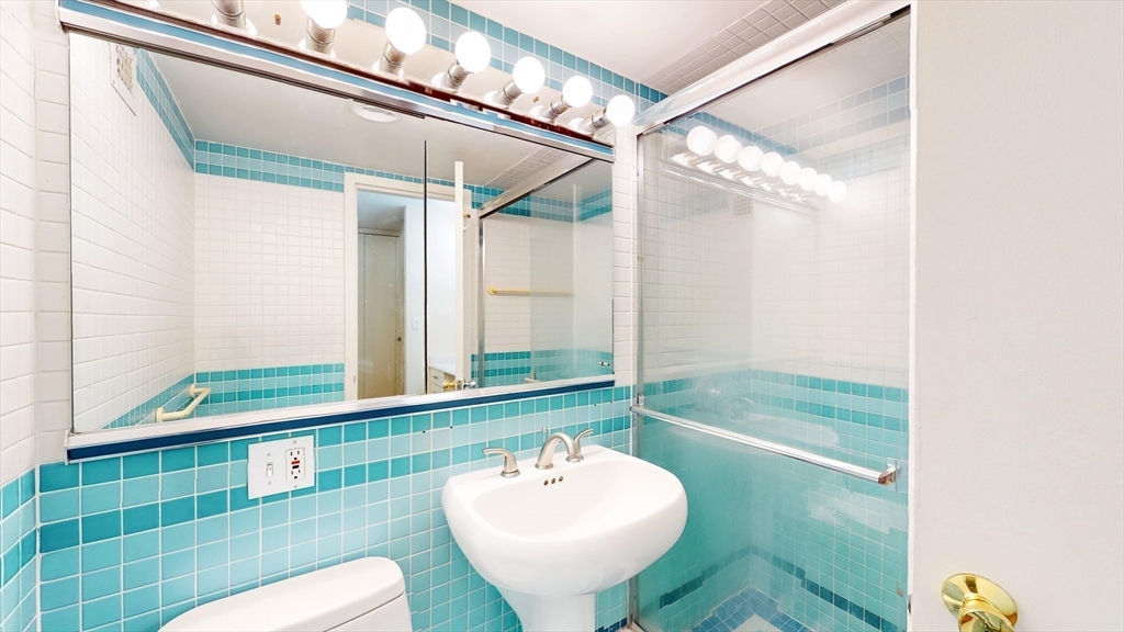 9 Hawthorne Place, Unit 11B Boston, MA 02114 - Photo 6 of 19 a bathroom with a sink and a mirror