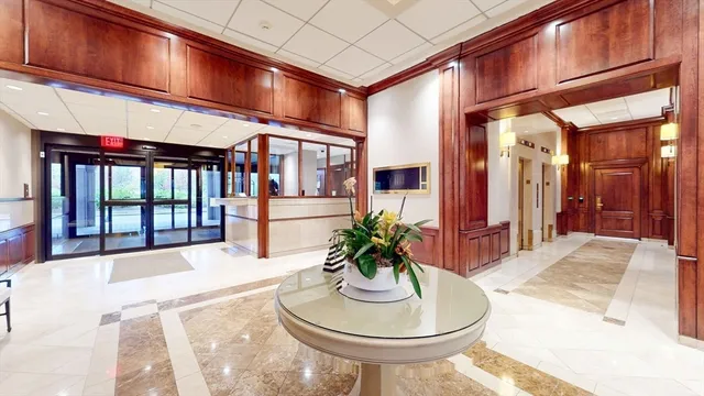 a lobby with furniture and potted plant