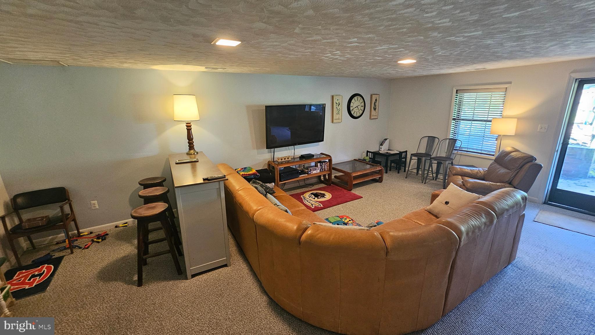 10921 Dumbarton Drive Dunkirk, MD 20754 - Photo 18 of 20 a living room with furniture a flat screen tv and a lamp