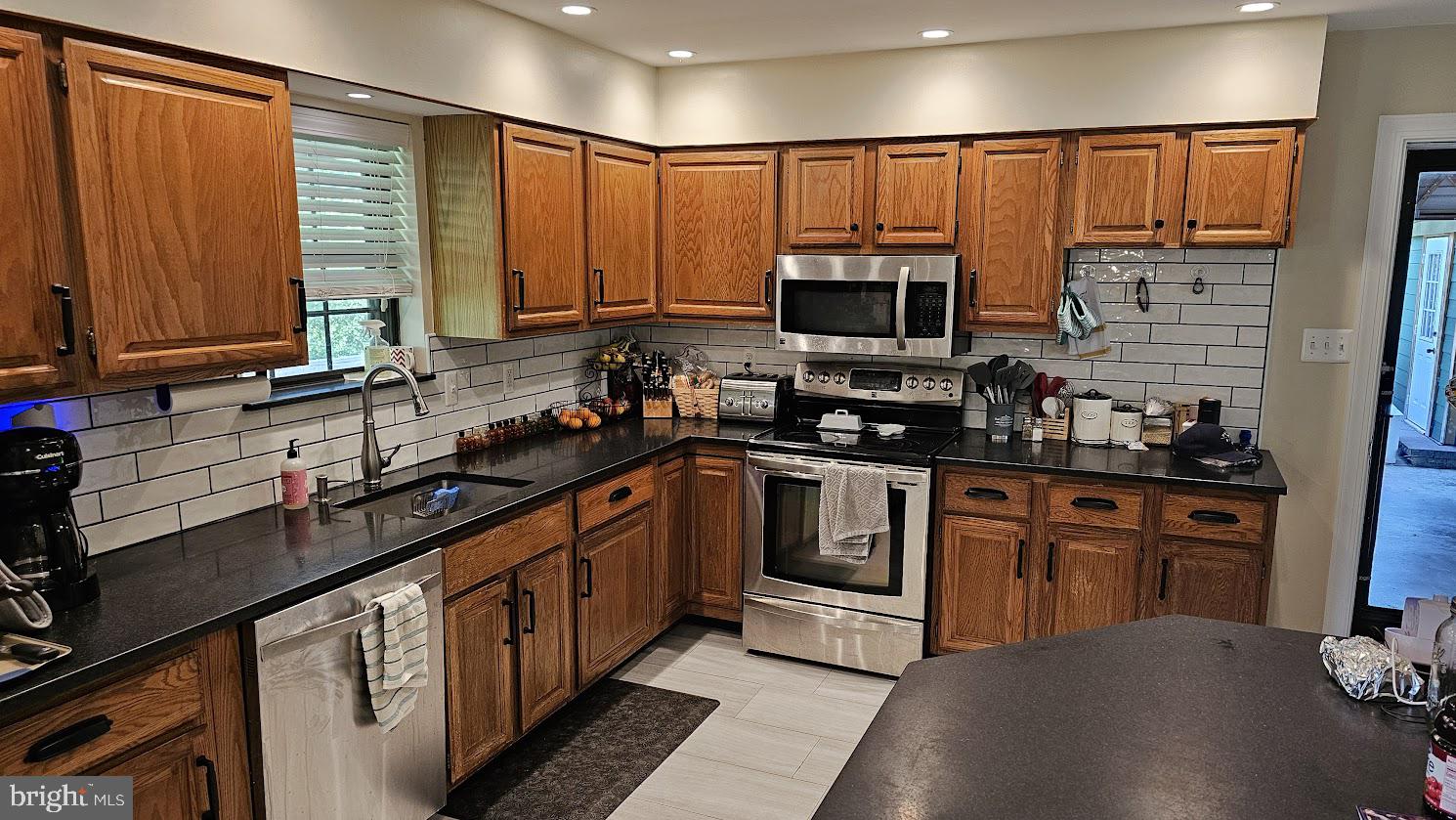 10921 Dumbarton Drive Dunkirk, MD 20754 - Photo 7 of 20 a kitchen with stainless steel appliances a sink cabinets and a window