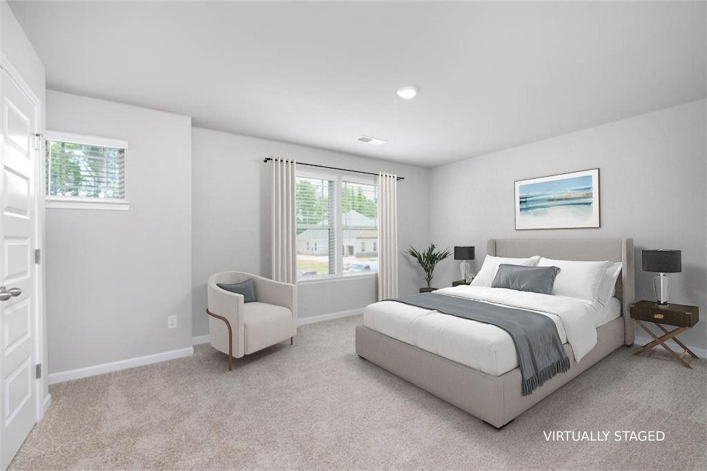 113 Canal Street Hampton, GA 30228 - Photo 23 of 33 a spacious bedroom with a bed and a couch