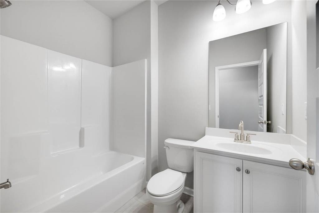 113 Canal Street Hampton, GA 30228 - Photo 29 of 33 a bathroom with a sink a toilet and shower