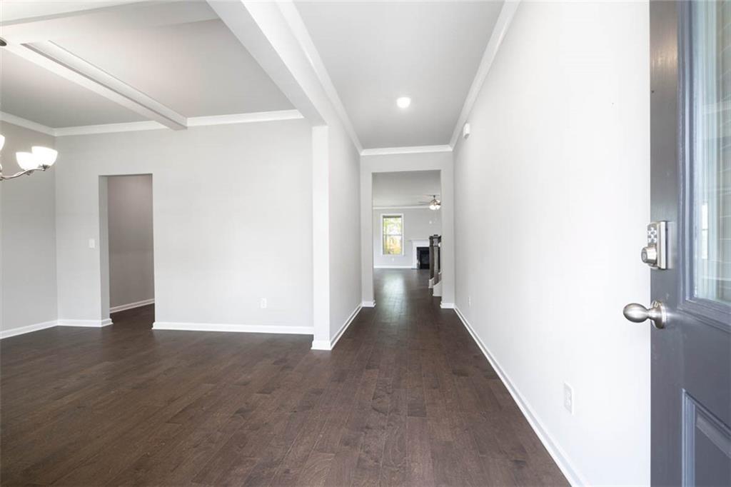 113 Canal Street Hampton, GA 30228 - Photo 3 of 33 a view of a hallway with wooden floor