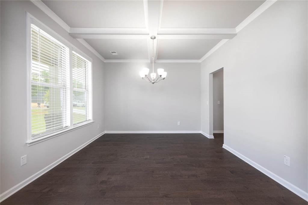 113 Canal Street Hampton, GA 30228 - Photo 5 of 33 an empty room with windows and ceiling fan
