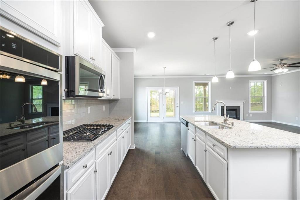 113 Canal Street Hampton, GA 30228 - Photo 7 of 33 a large kitchen with stainless steel appliances a stove sink and cabinets