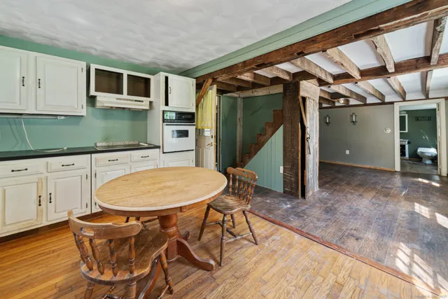 a room with wooden floors and pool table