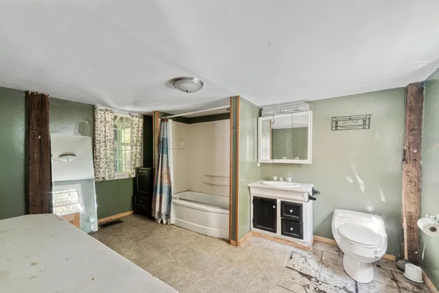 a spacious bathroom with a toilet sink and shower