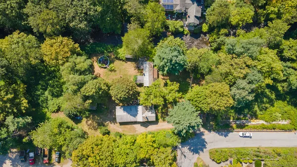 an aerial view of a house with a yard