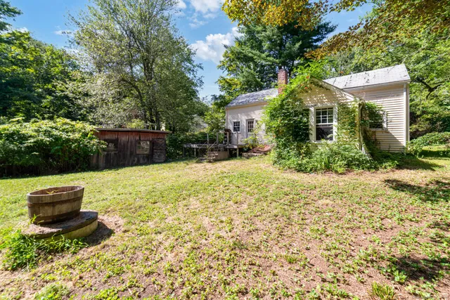 a view of a backyard with table and chairs and potted plants
