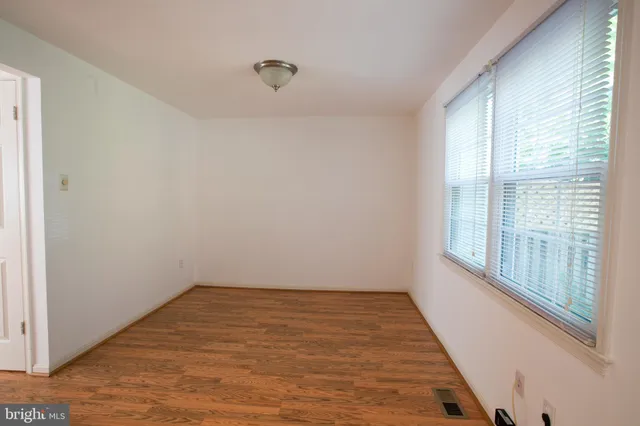 a view of a room with wooden floor and windows