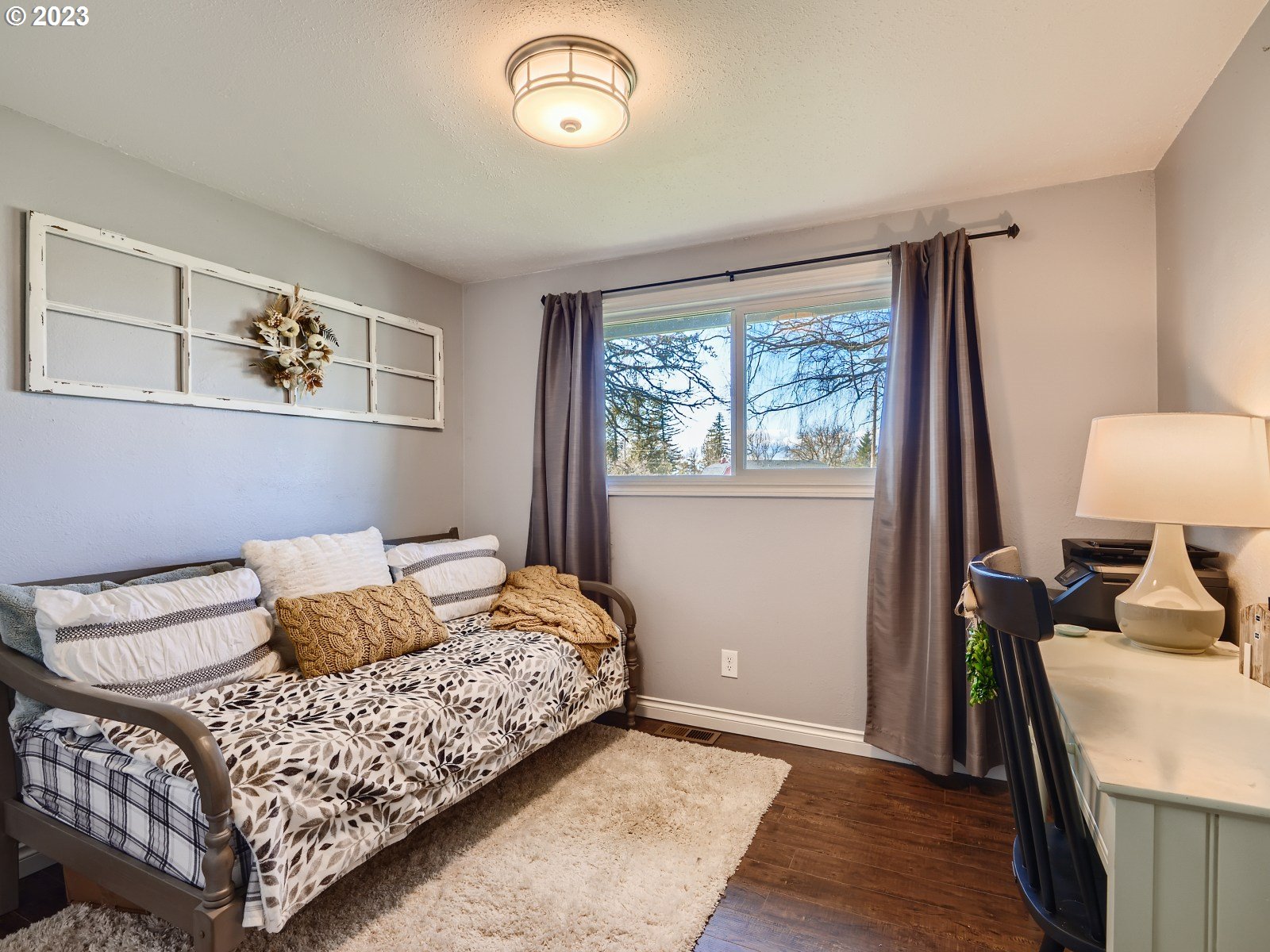 1830 Southeast Christensen Road Corbett, OR 97019 - Photo 17 of 28 a bedroom with a bed and a dresser next to a window
